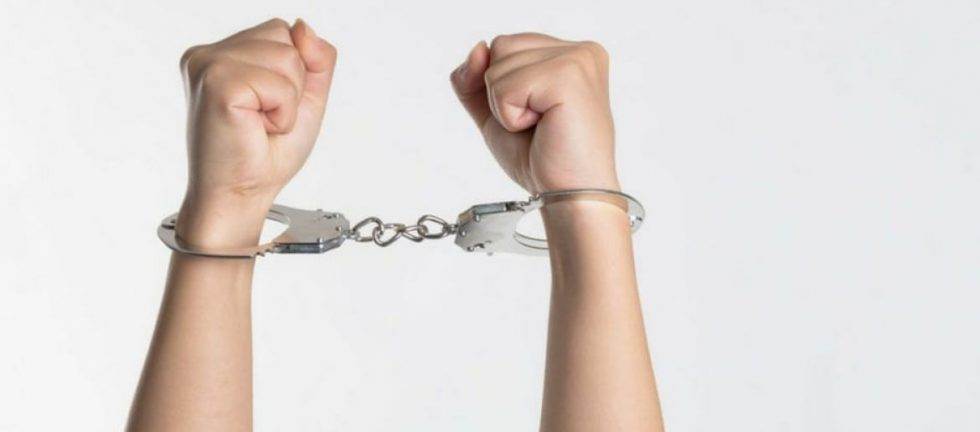 Close-up of hands handcuffed together