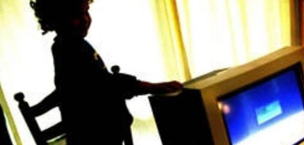 Silhouette of a child interacting with a television, illustrating the dangers of online child exploitation.