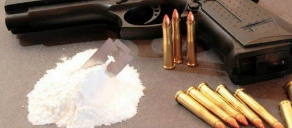 Handgun, bullets, and cocaine on a table; drug violence
