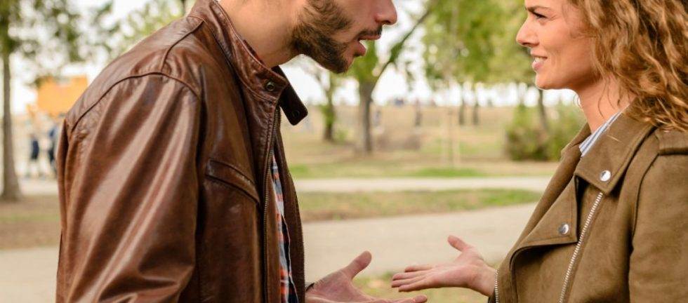Angry couple arguing outdoors, relationship problems, conflict resolution