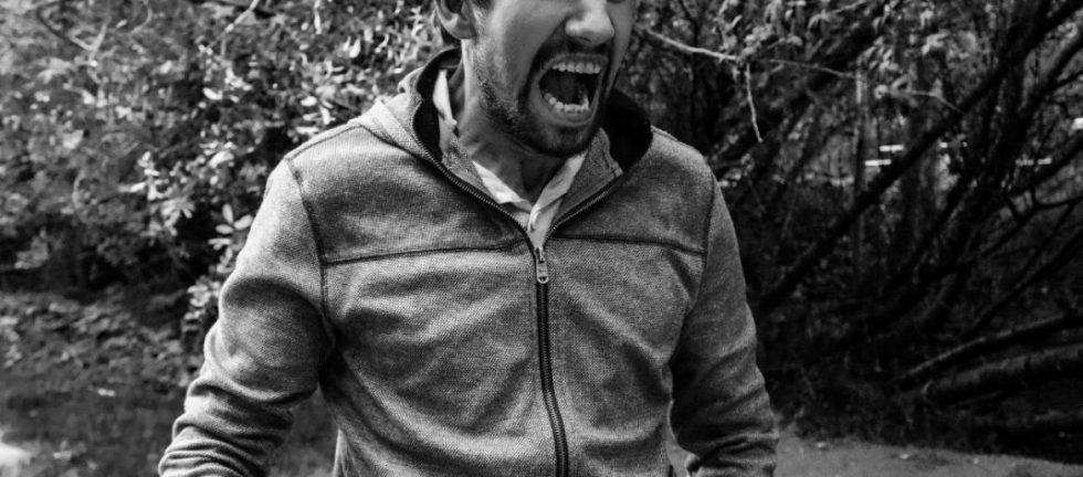 Angry man shouting outdoors