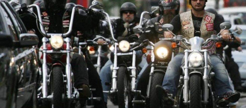 Motorcycle club riding custom bikes on city street