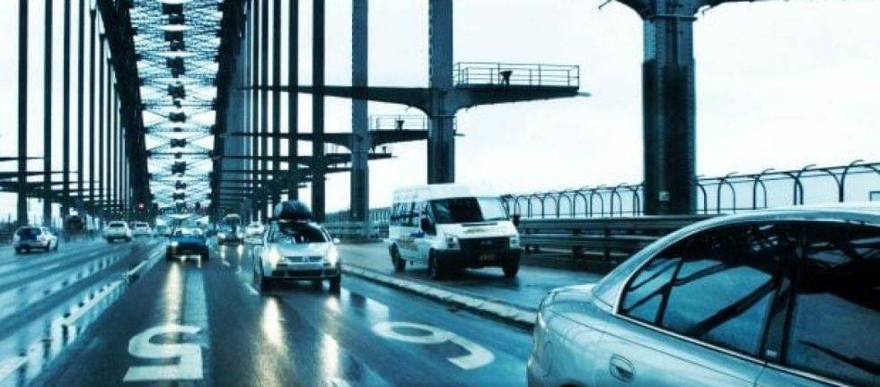 Cars driving across a bridge on a cloudy day. New traffic laws may impact drivers.