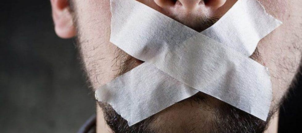 Man's mouth covered with tape; silence in court