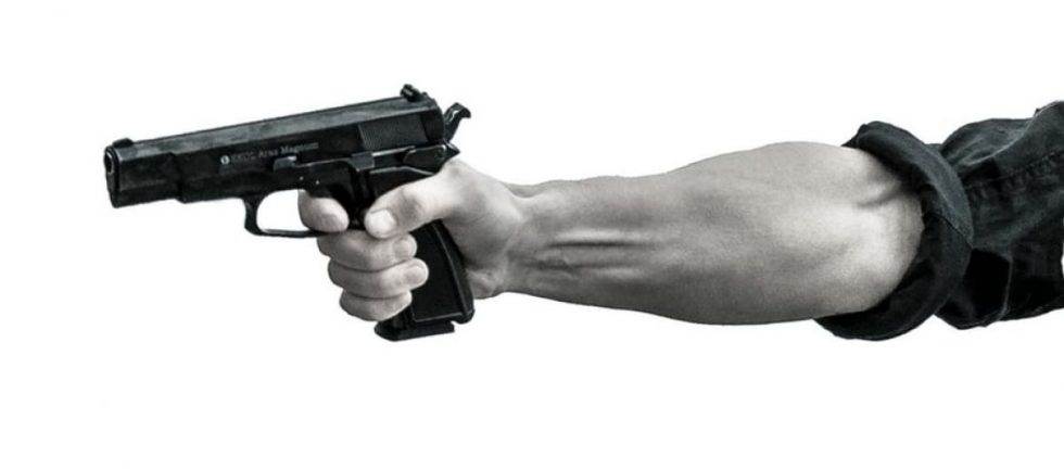 Close-up of a hand holding a handgun.