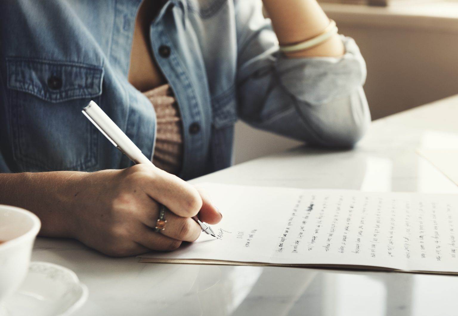 Woman writing sincere apology letter for court.