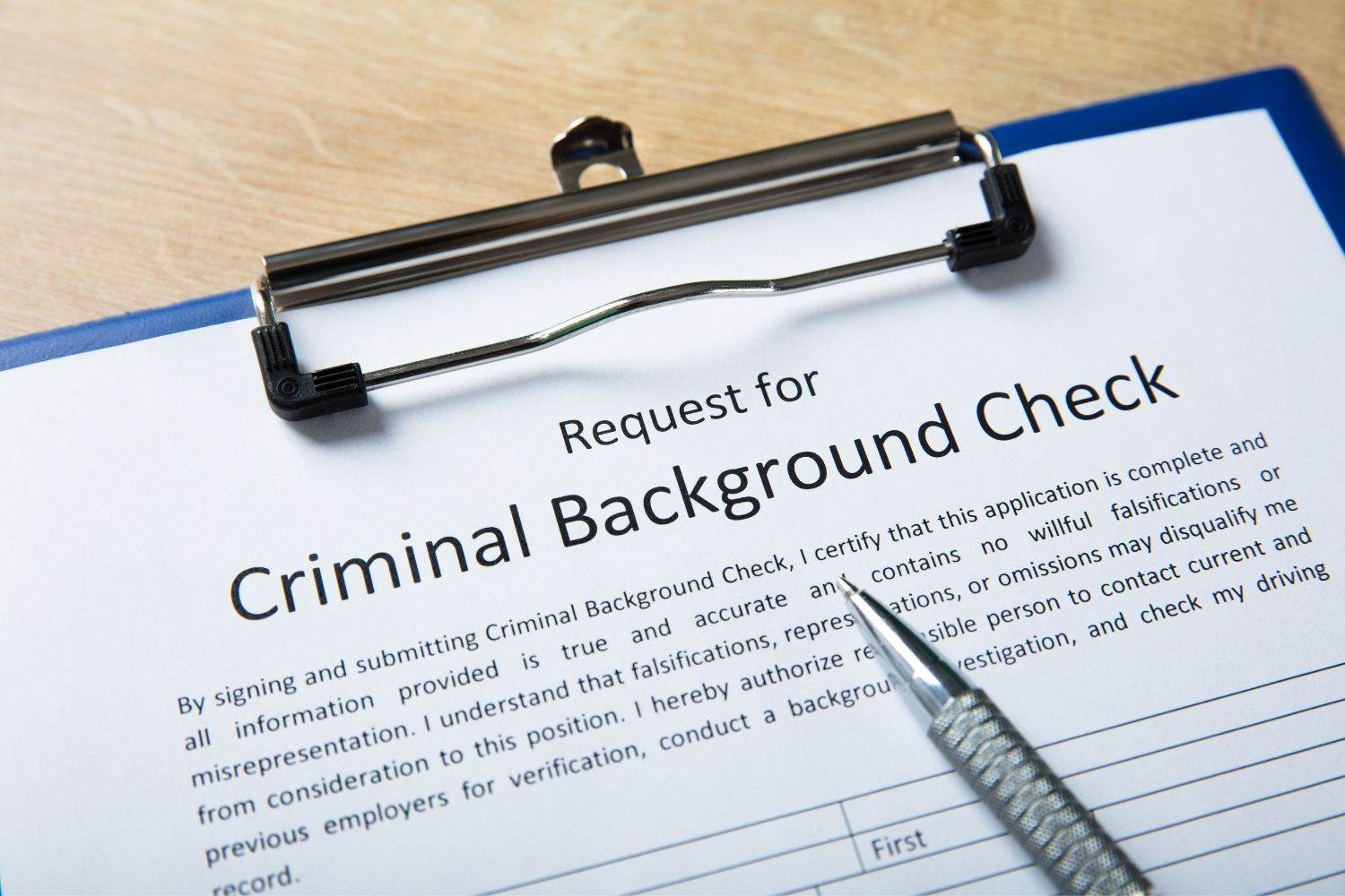 Criminal background check request form with pen. NSW criminal record information.