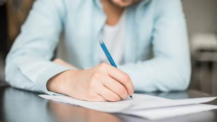 Person writing apology letter for assault charges.
