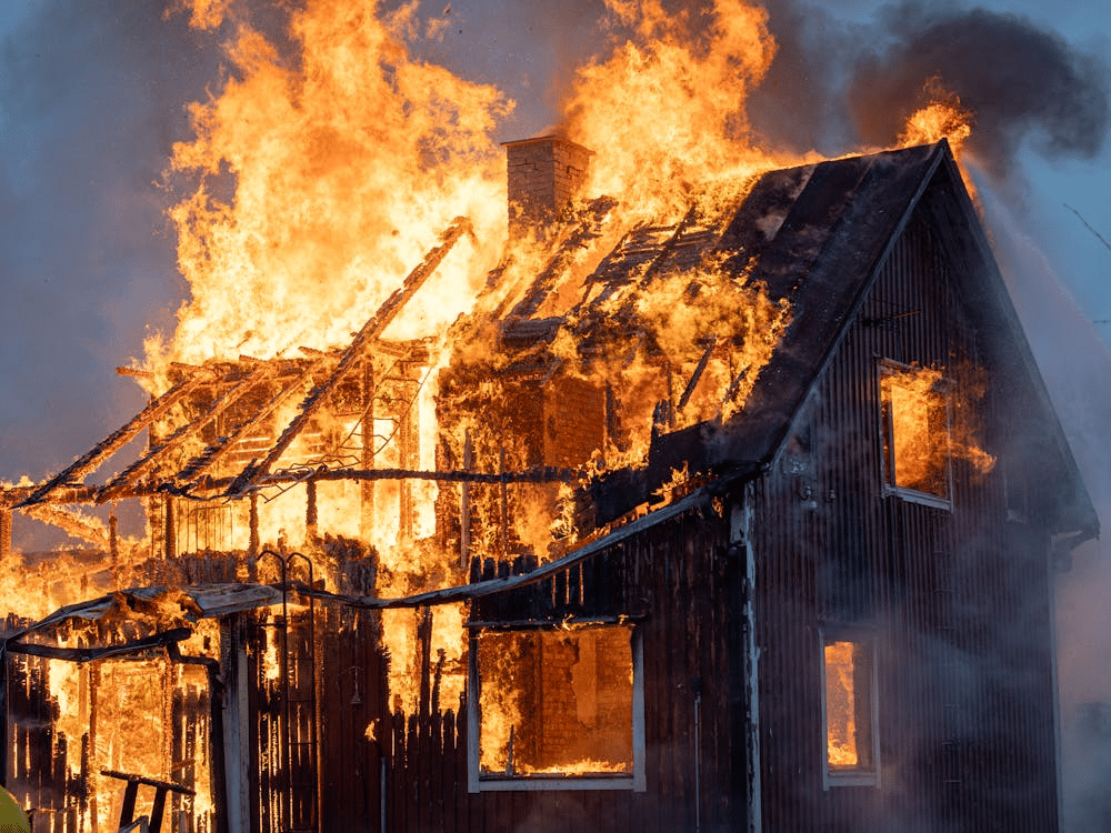 A house engulfed in flames, illustrating the devastating consequences of arson in NSW.