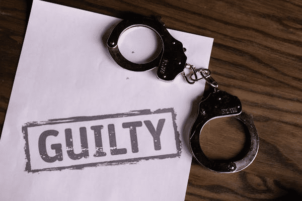 Handcuffs on a paper with "Guilty" stamped, illustrating a guilty plea in NSW Local Court.
