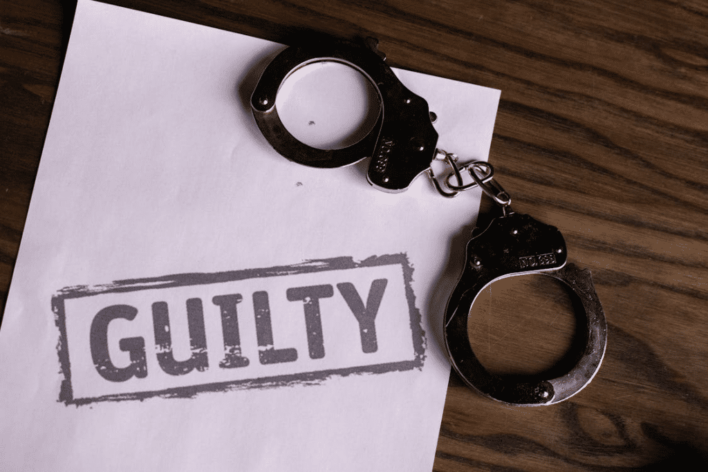 Handcuffs on paper with "Guilty," symbolising pleading guilty to a drug charge in NSW.