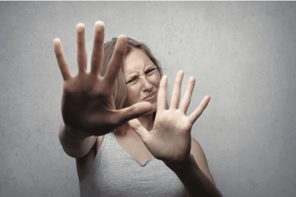 Person with hands raised defensively; related to NSW self-defence laws explained.