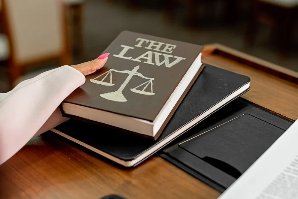Close-up of a hand holding a law book, symbolizing legal rights and procedures in The Children's Court of NSW.