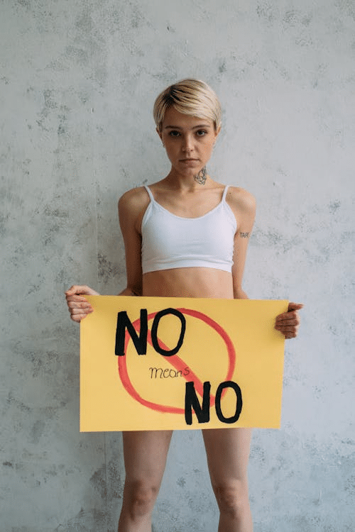 Person holding a sign that reads "No means no," emphasizing Affirmative Consent Laws in NSW and sexual consent in New South Wales.