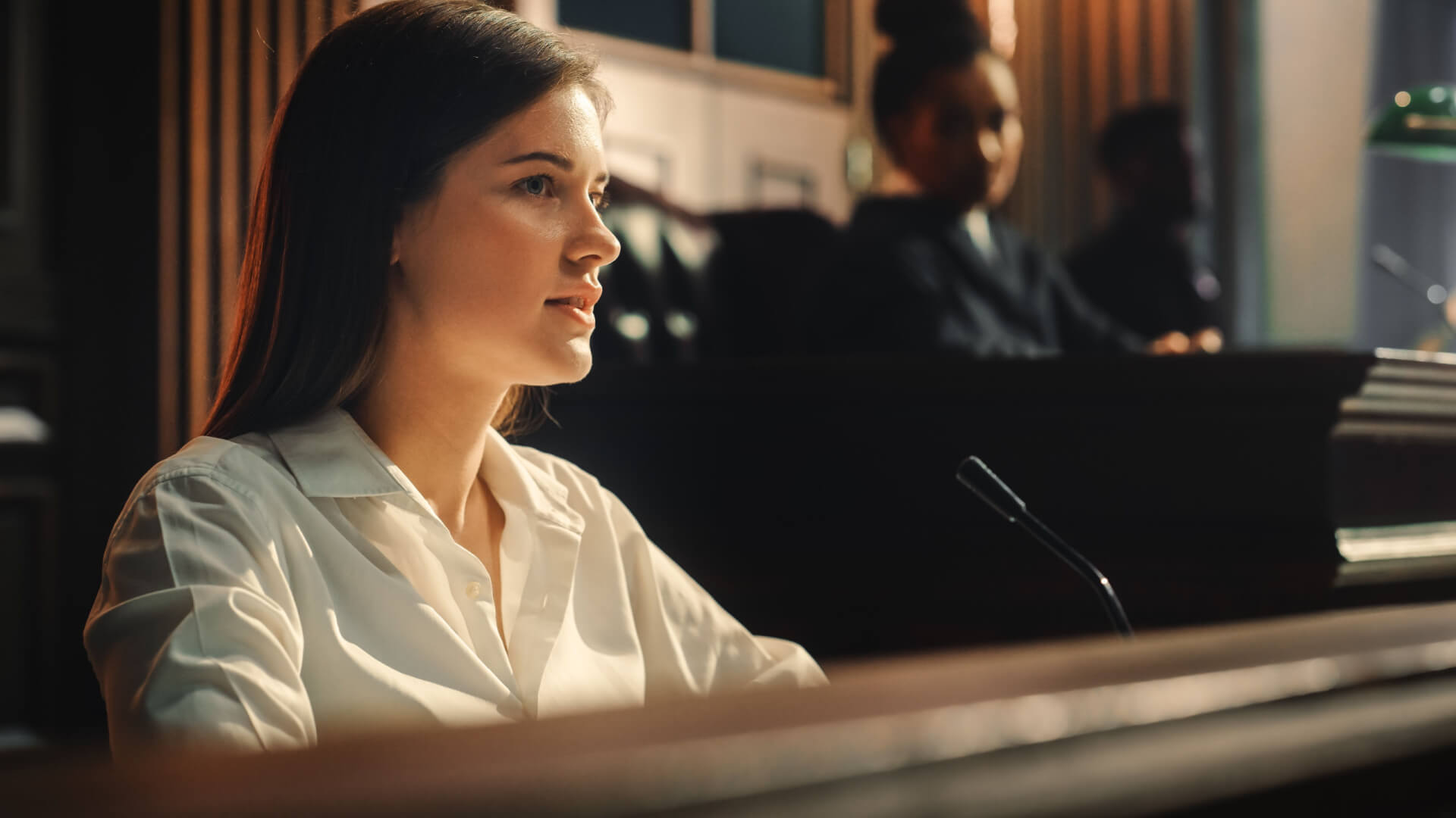 A woman testifying in a courtroom, illustrating "Managing Unfavorable or Hostile Witnesses in NSW Courts: Legal Guide.