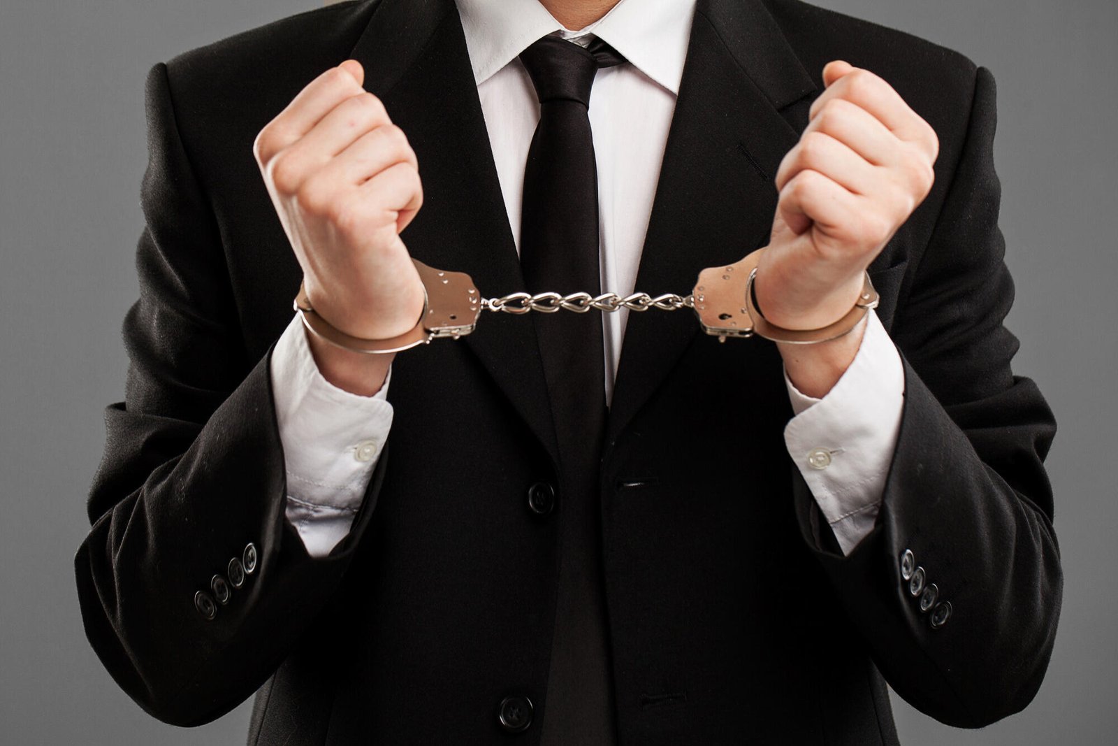 Person in a business suit in handcuffs, symbolizing corporate crime in NSW.
