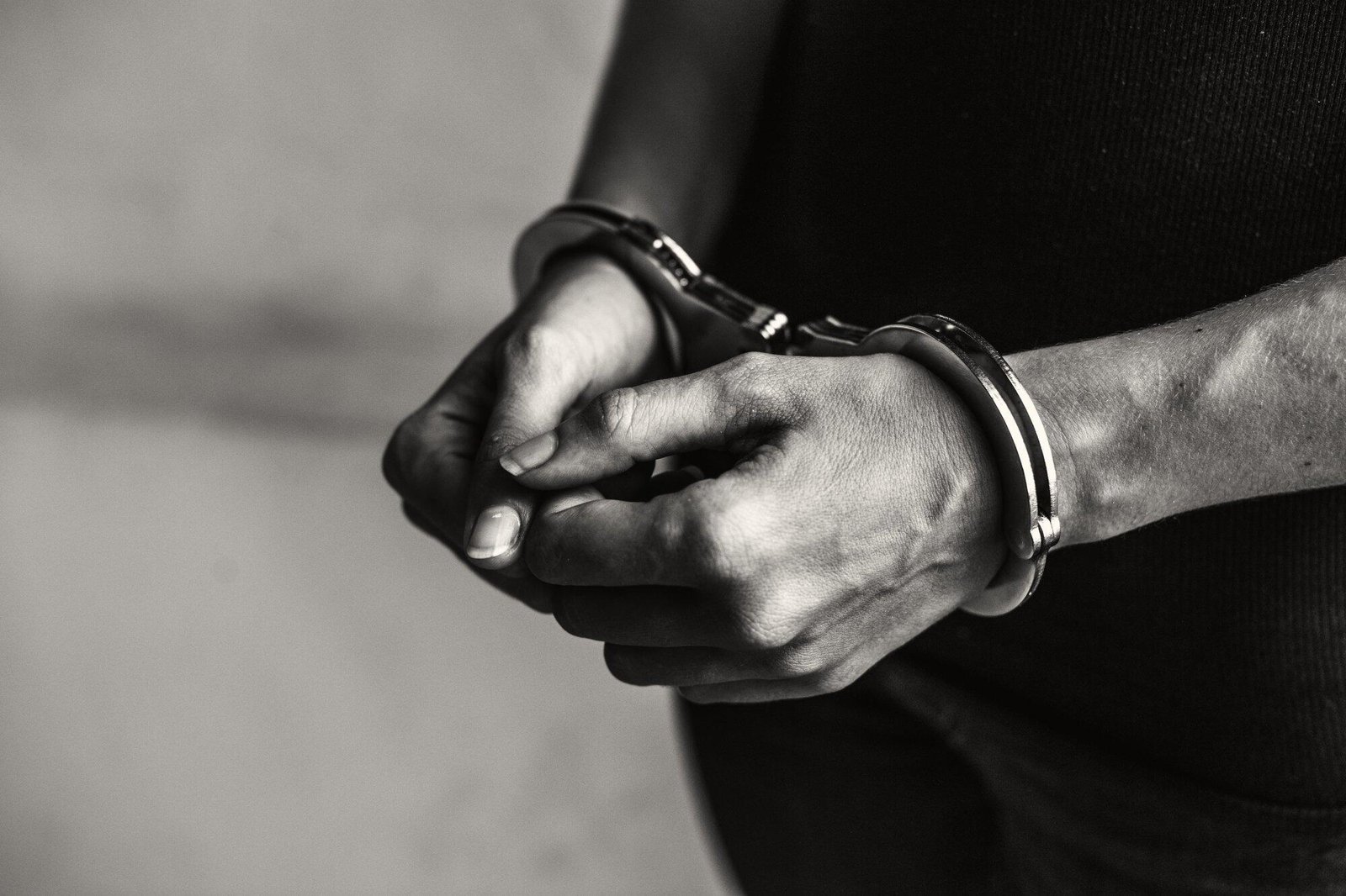 Close-up of hands in handcuffs, symbolizing wrongful arrest in NSW and highlighting the option to sue police.