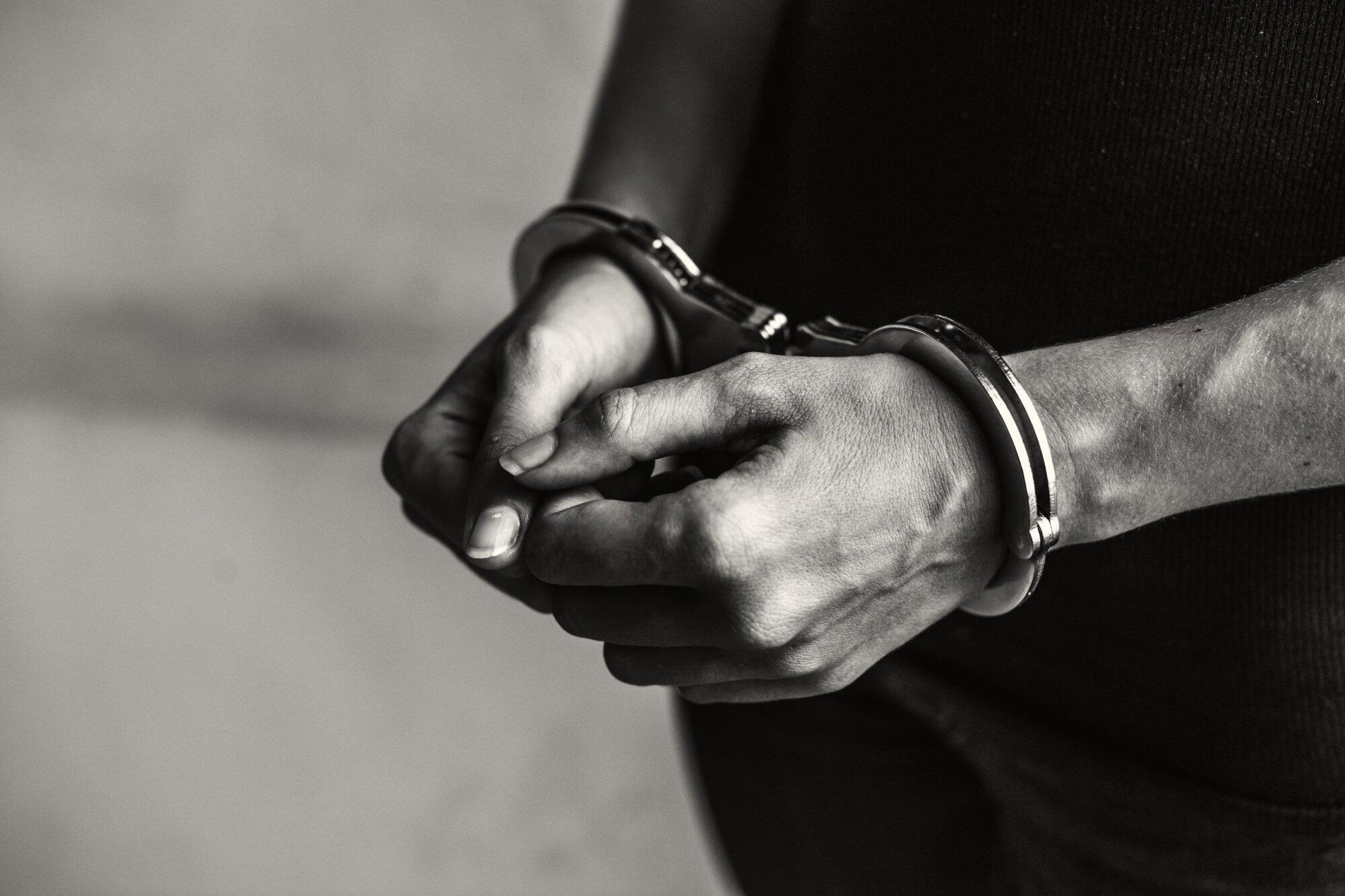 Close-up of hands in handcuffs, symbolizing wrongful arrest in NSW and highlighting the option to sue police.