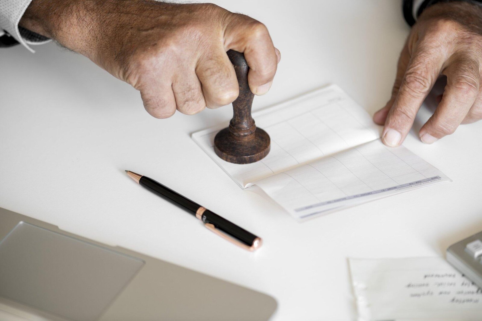 Close-up of a hand stamping a document, symbolizing legal authority, related to Strip Search Laws and Rights in NSW.