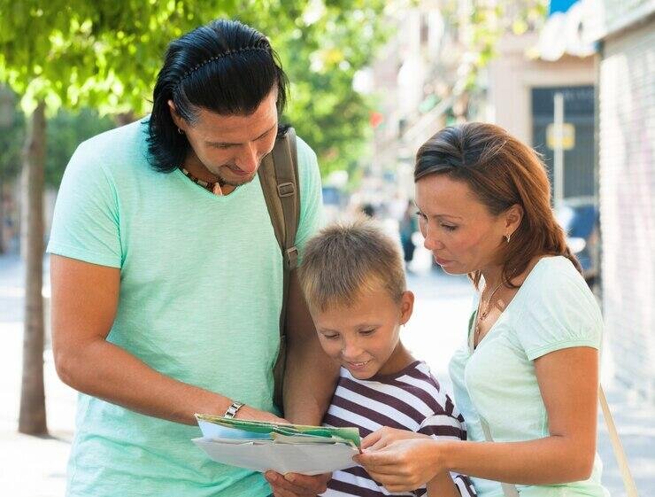 Family with child looking at a map, planning a trip.