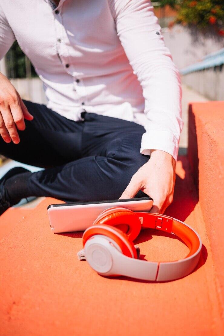 Person using headphones and tablet. NSW privacy laws.