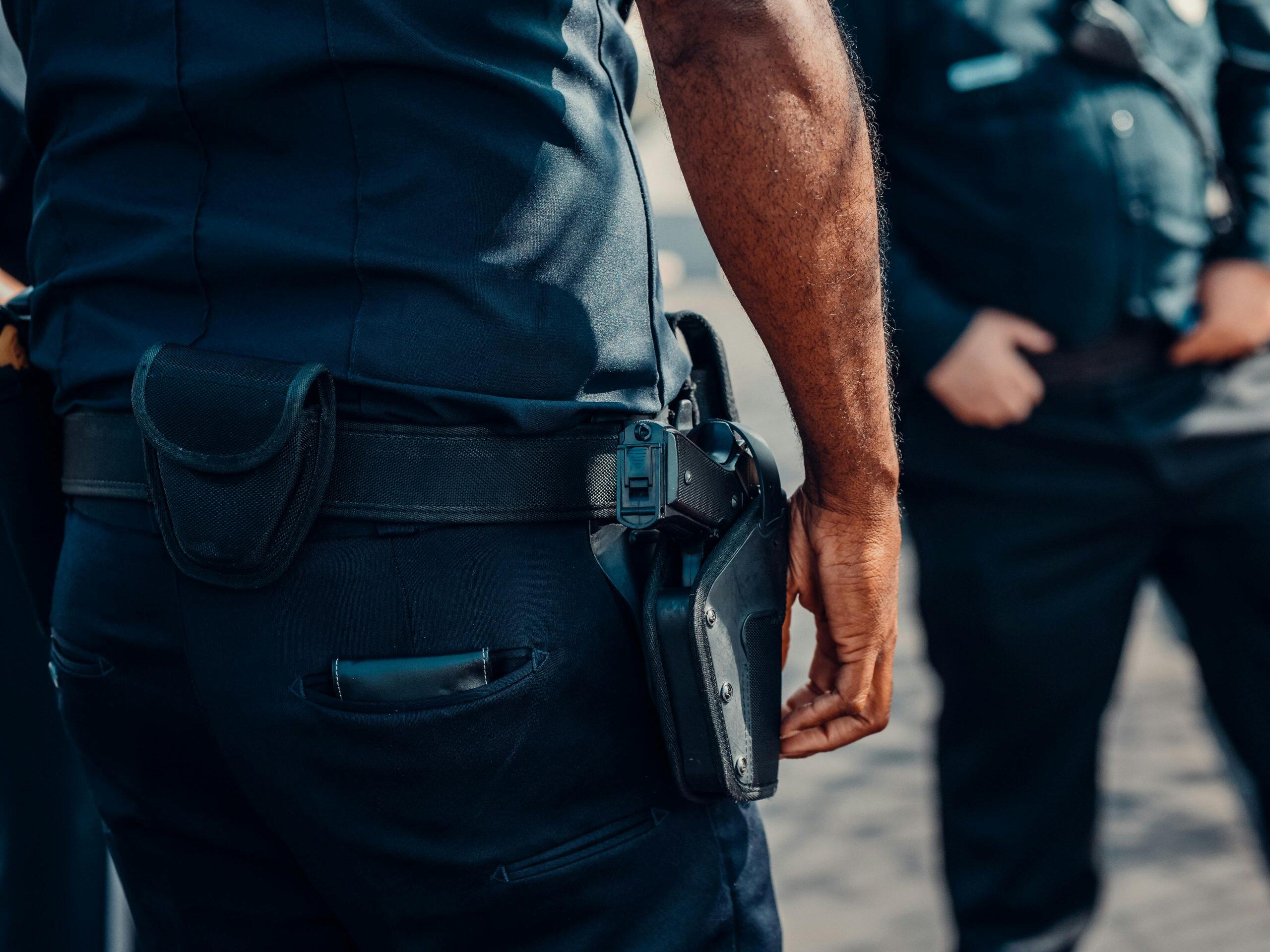Close-up of a police officer's sidearm holstered at the hip. NSW Firearm Prohibition Order.