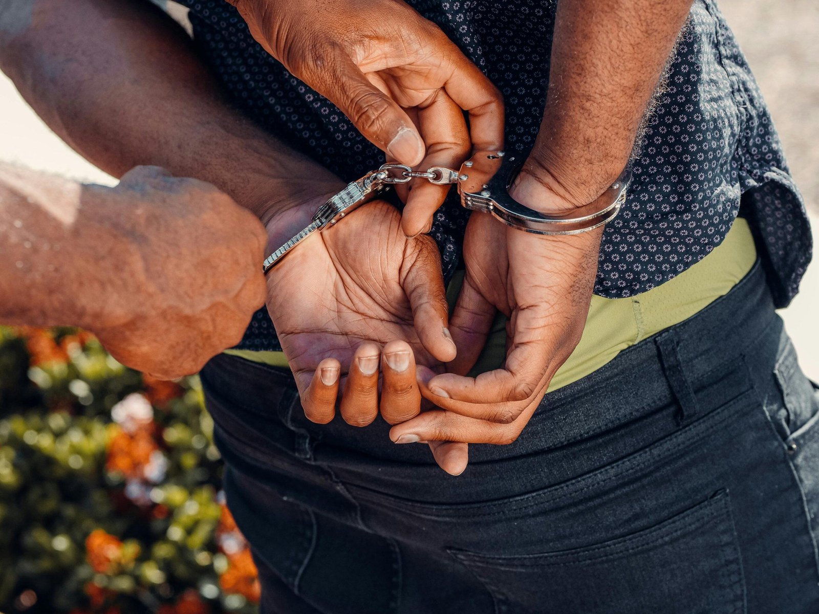 Close-up of hands being handcuffed by police officer. Assaulting Police NSW.
