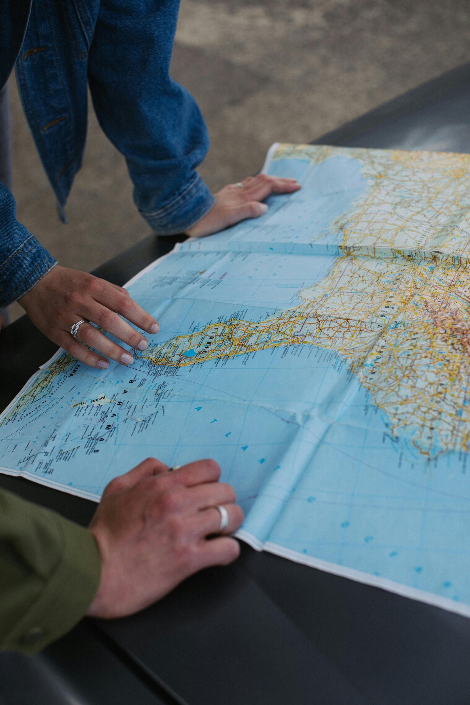 Two people studying a detailed map, planning a route.