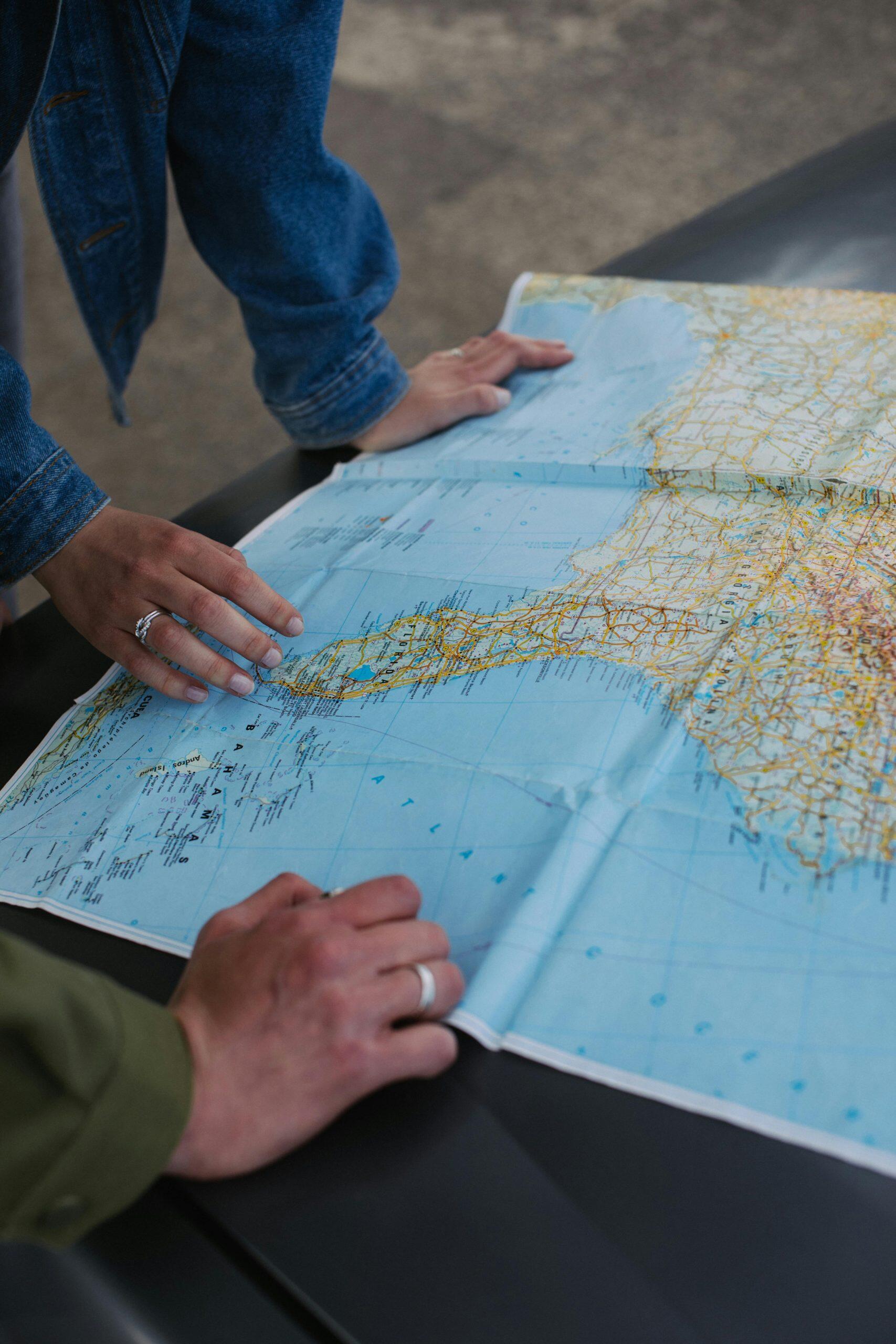 Two people studying a detailed map, planning a route.