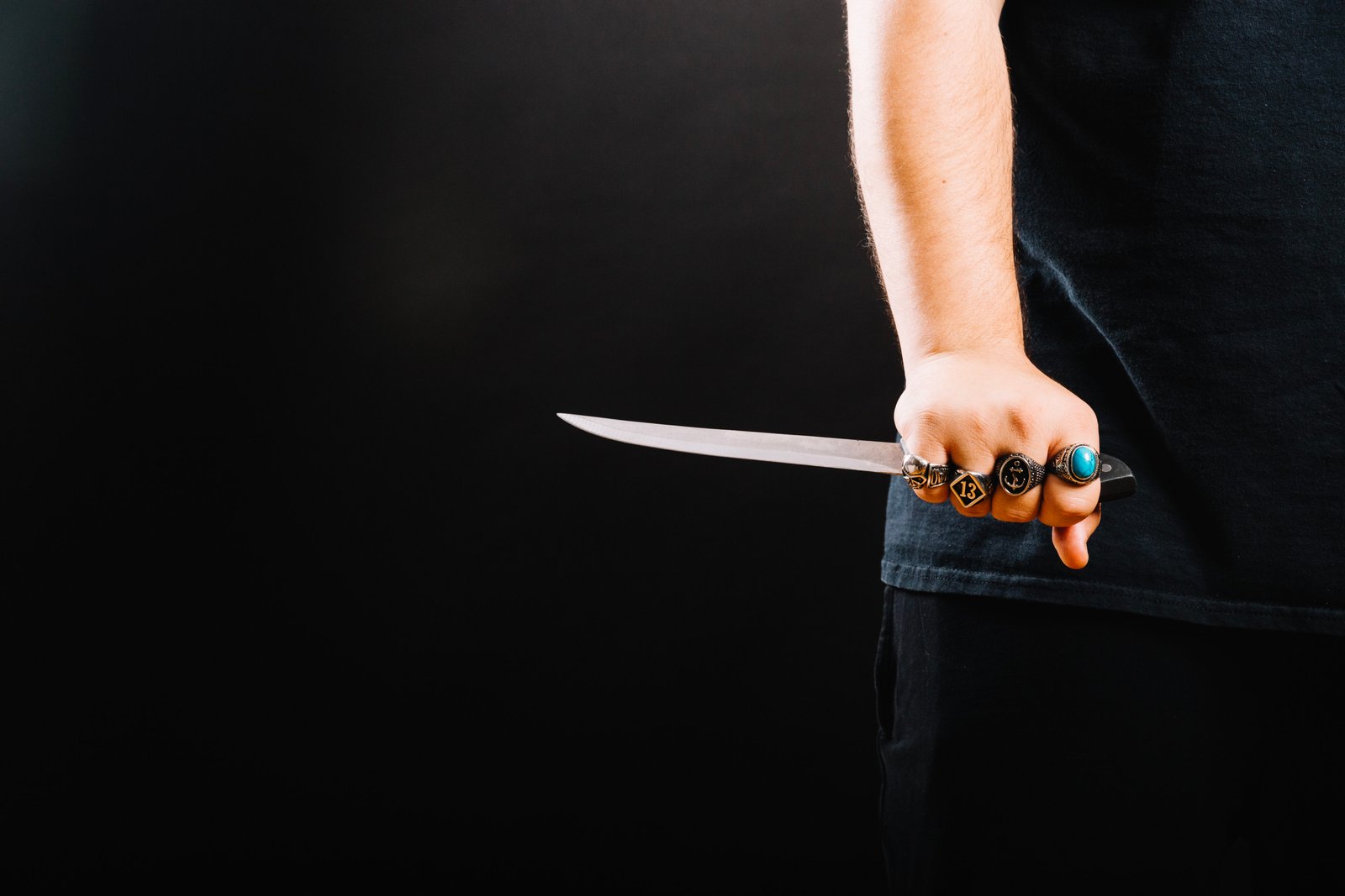 Close-up of a hand holding a knife; relevant to legal aspects of murder in NSW.