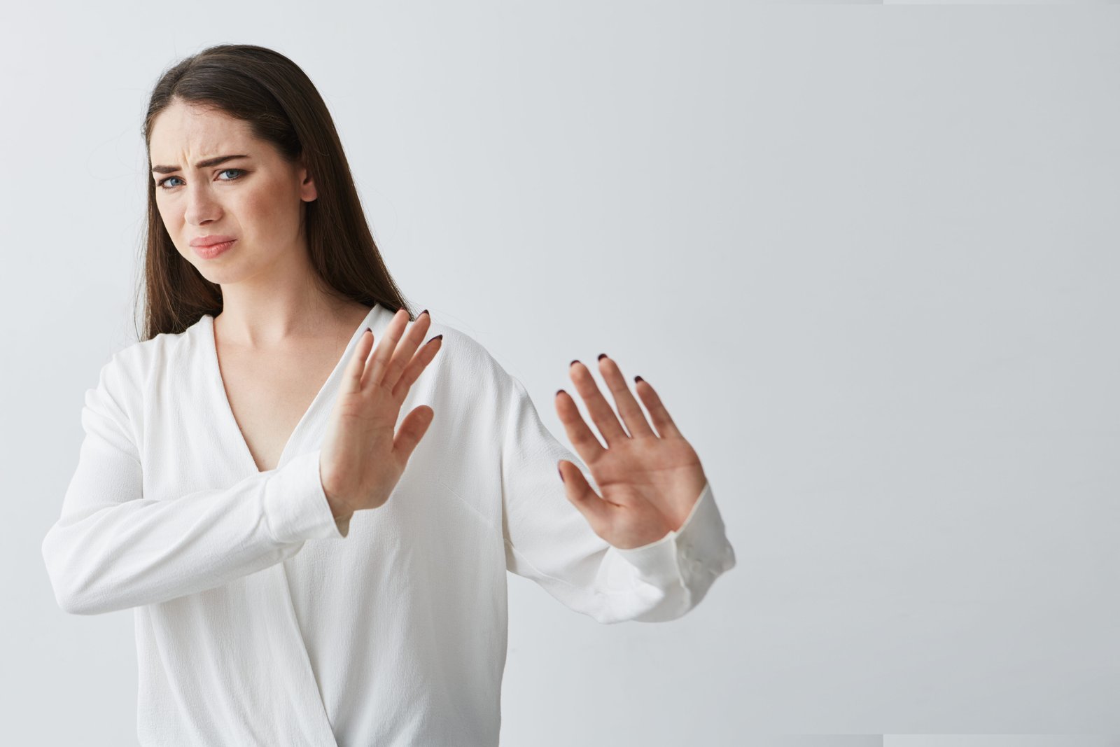 Woman showing a stop gesture with both hands